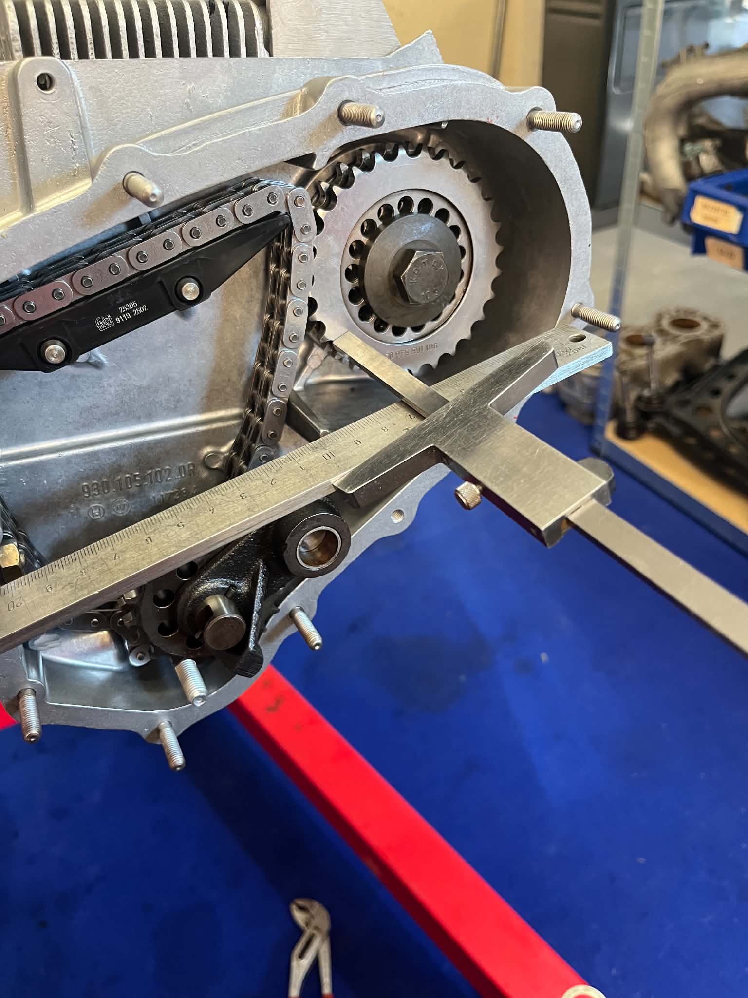 Vernier caliper checking timing gear and chain alignment on the case